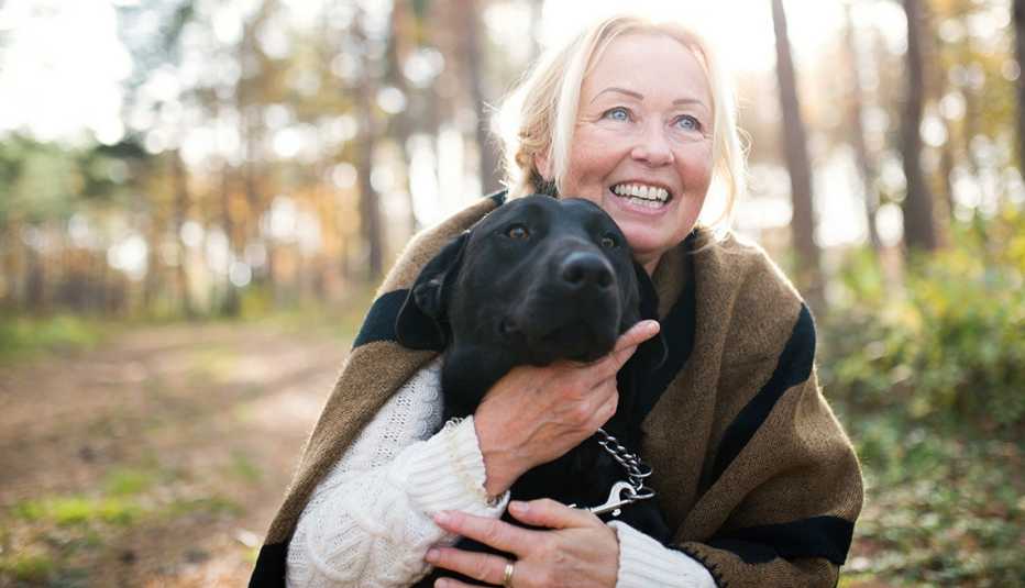 A woman with a black dog
