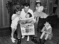 John Wayne reading to four of his children