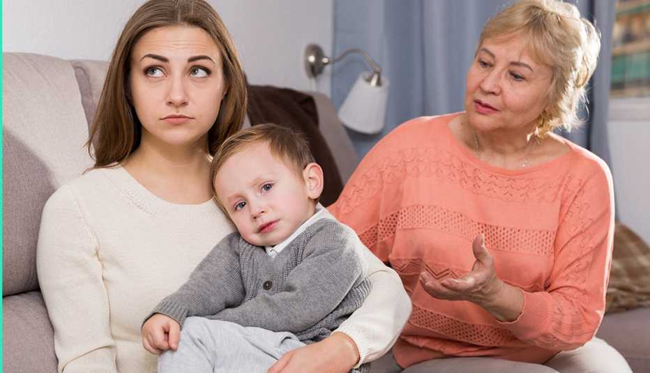 Two adult female are having disagreements with upbringing kid at home.