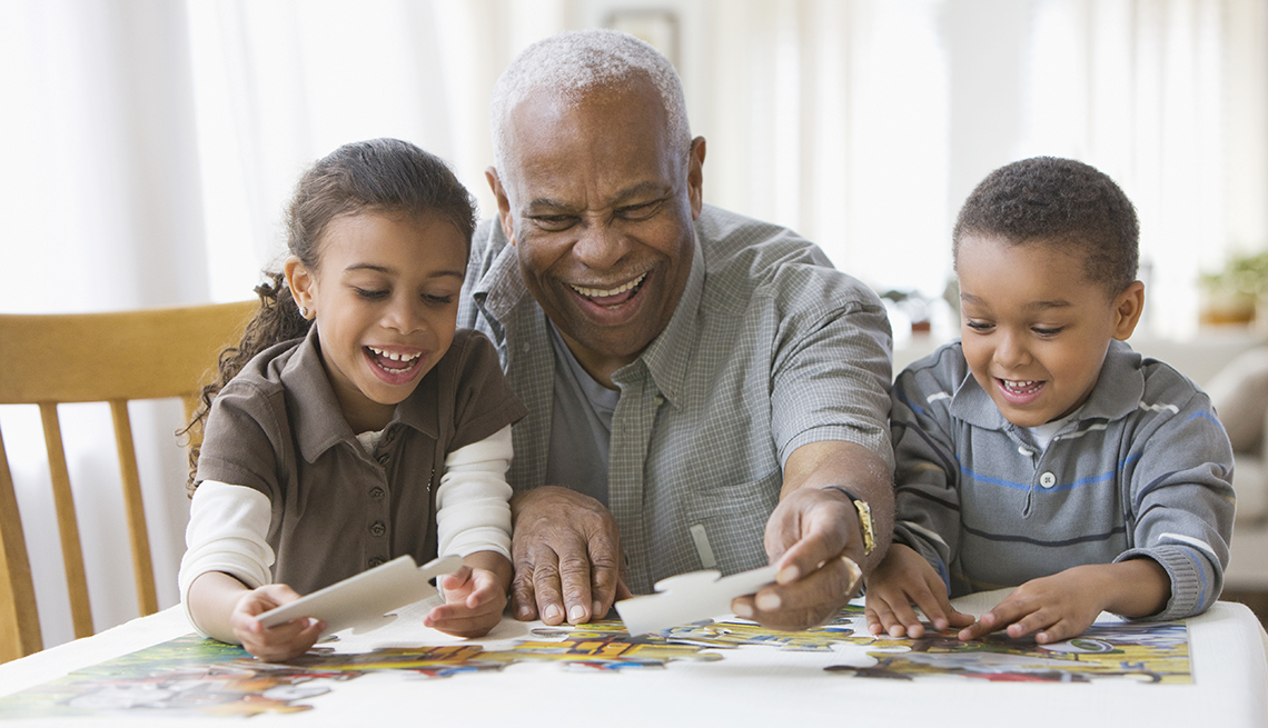 Grandparent and grandchildren building a puzzle