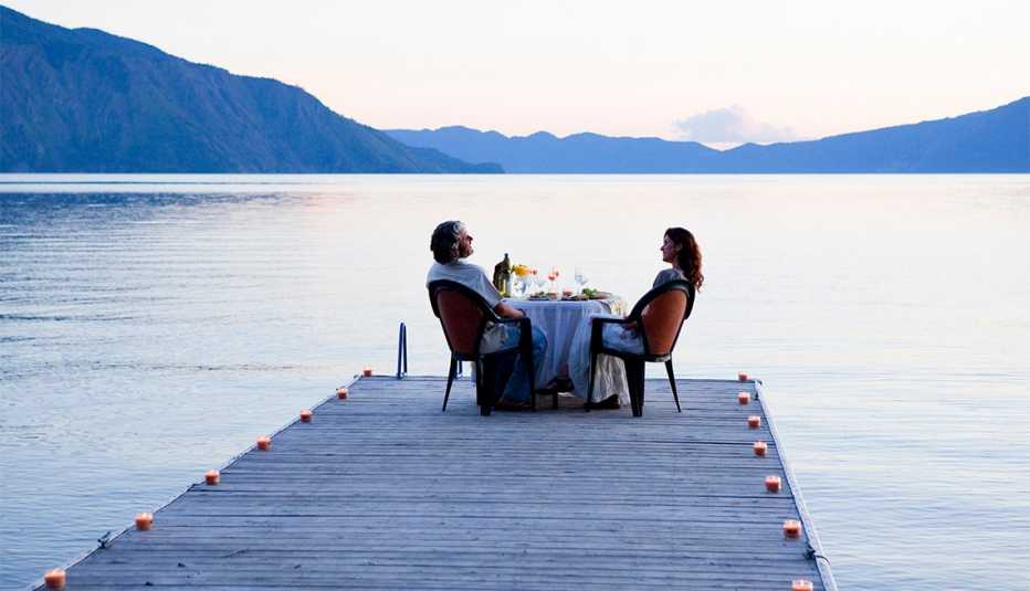 couple eating dinner on a pier