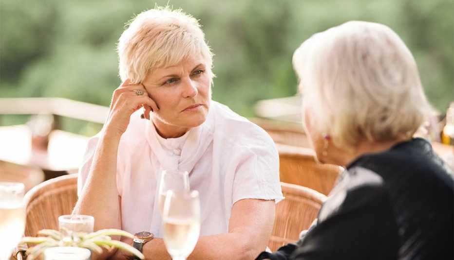 Shot of two women sitting at outdoor cafe and talking