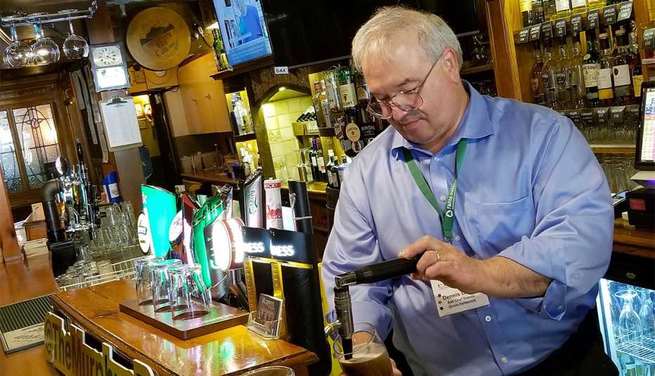 A man pours beer out of a brew machine