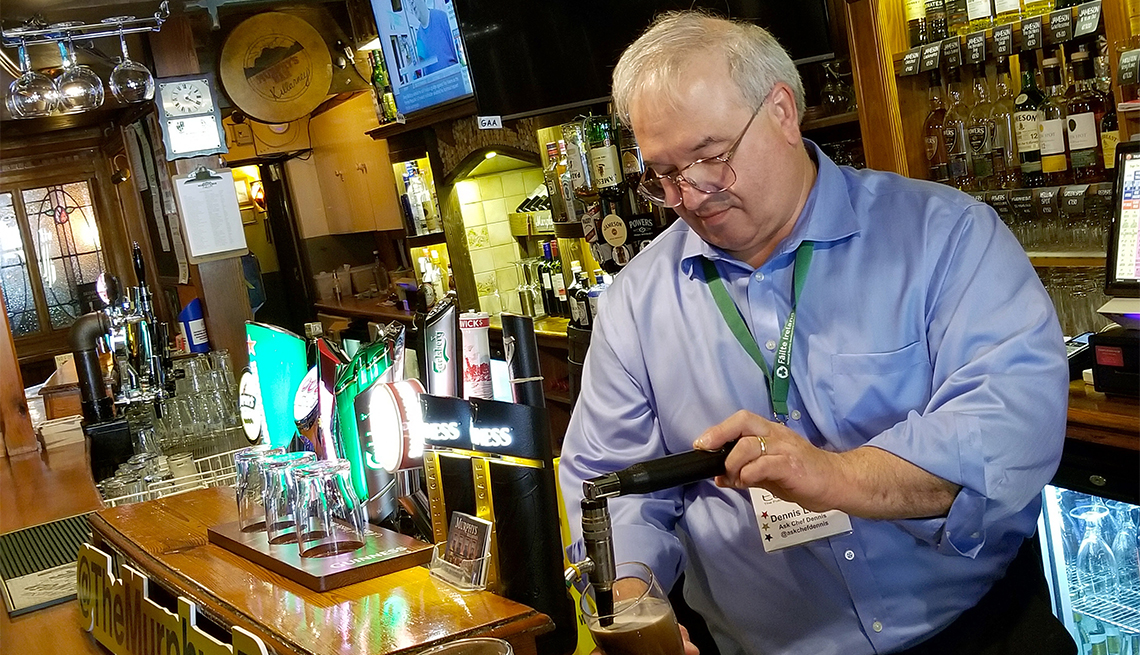 A man pours beer out of a brew machine