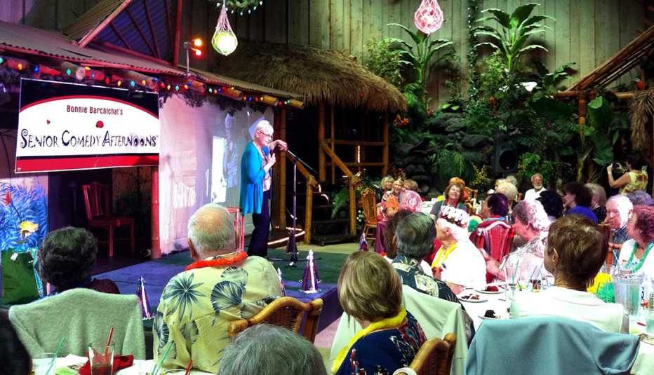 mature woman on stage in front of audience mature woman on stage in front of audience