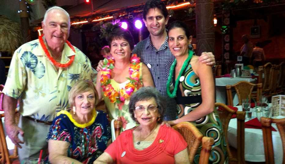 multigenerational family seated together in venue with tables