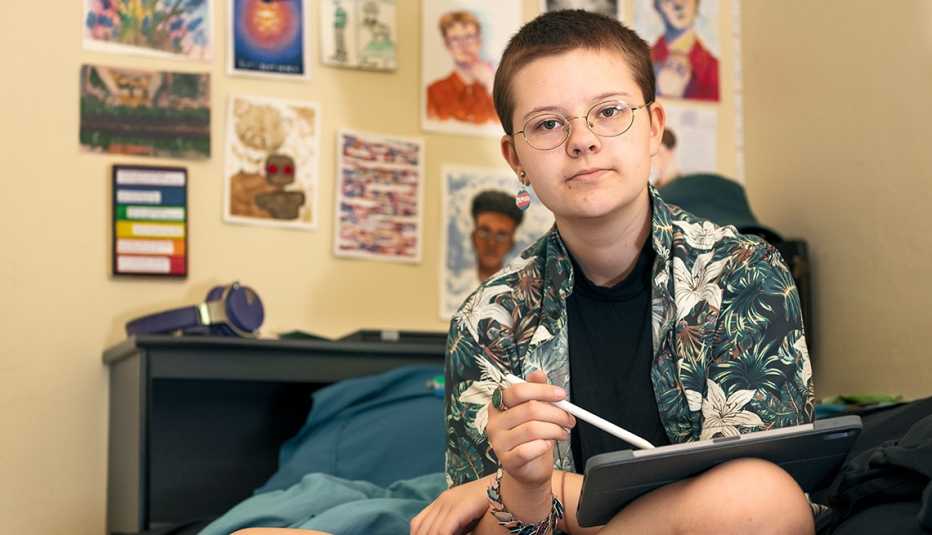 teenager river sits in his room