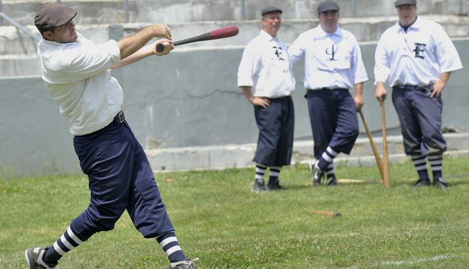 A man swings a bat at a baseball game