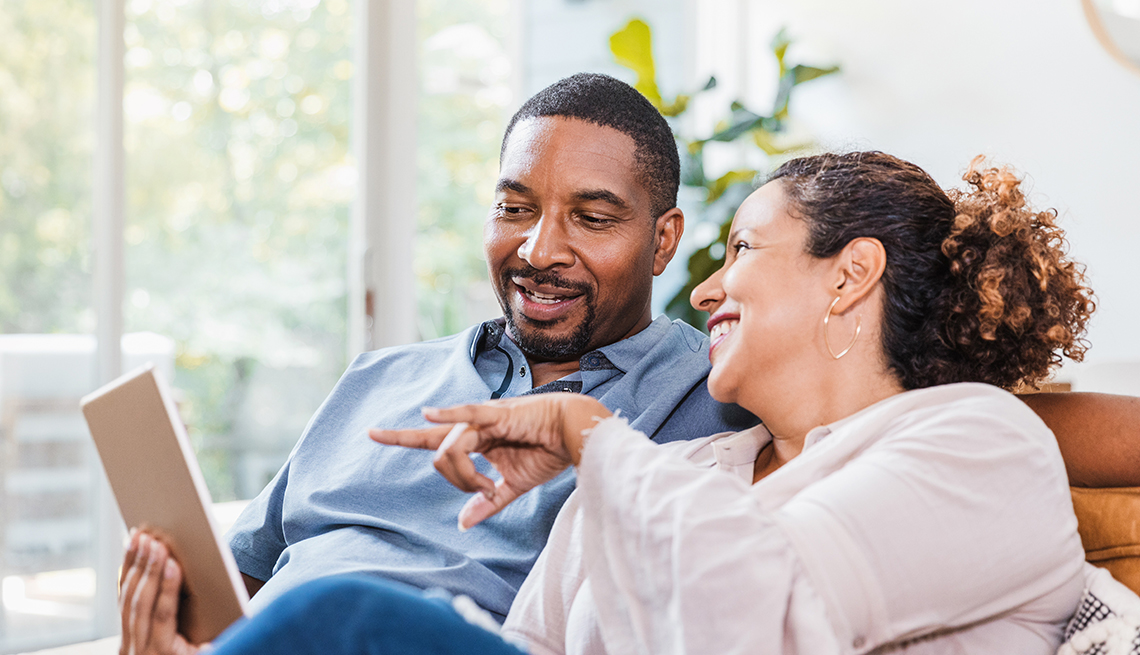Couple playing online games on couch