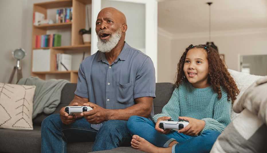 grandfather and granddaughter playing games at home