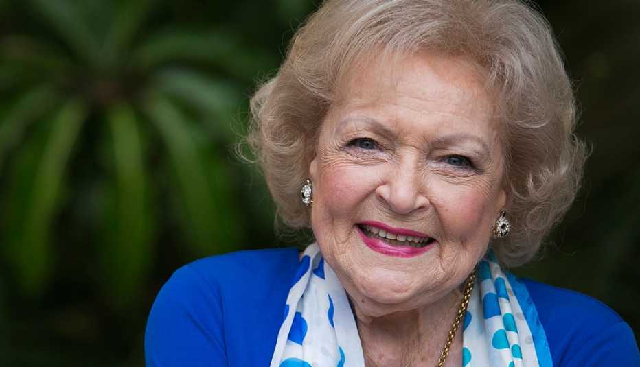 Betty White smiling, wearing a blue shirt