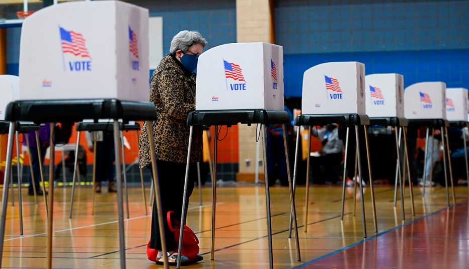 A woman is voting in a voting booth during the election A woman is voting in a voting booth during the election