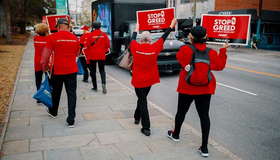 Volunteers in South Carolina in red shirts walk down the streets holding signs Volunteers in South Carolina in red shirts walk down the streets holding signs