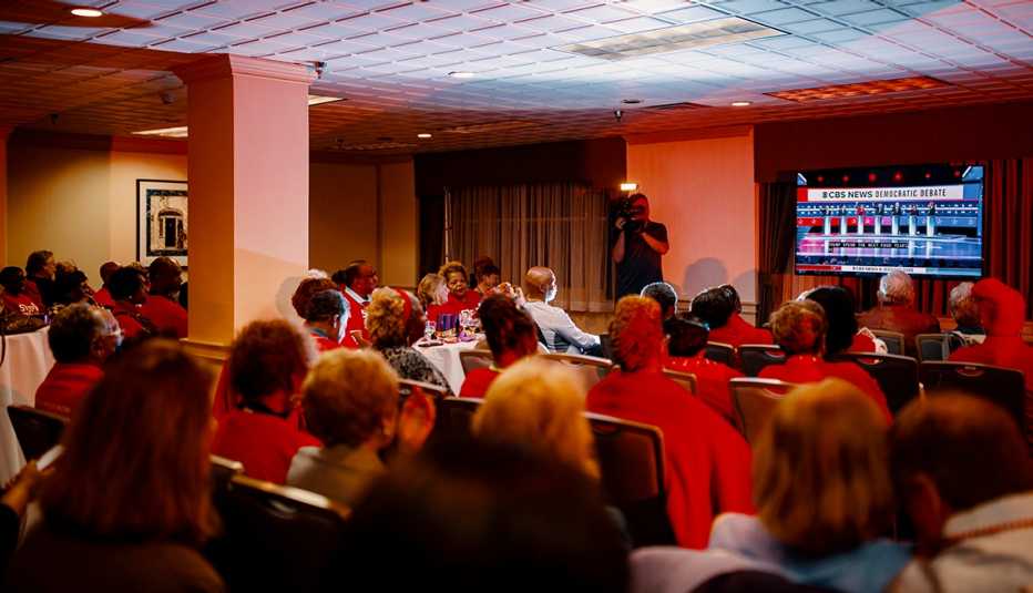 Volunteers wearing red shirts watching the debate in South Carolina Volunteers wearing red shirts watching the debate in South Carolina