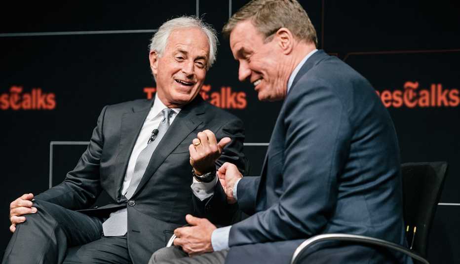 Sen. Mark Warner (D-VA) and Sen. Bob Corker (R-TN), talk politics during a conference 