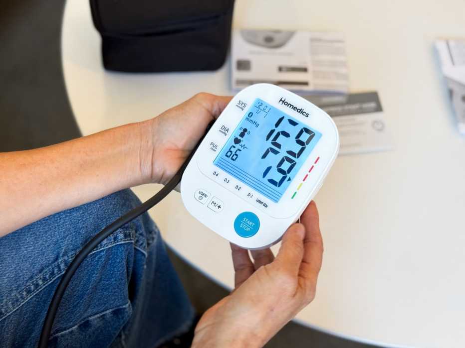  A woman takes her blood pressure reading using the Homedics blood pressure monitor. 