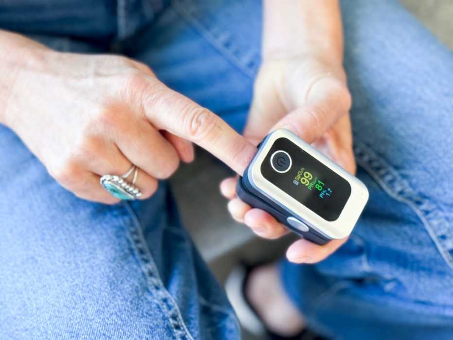 a person putting their finger in an oximeter