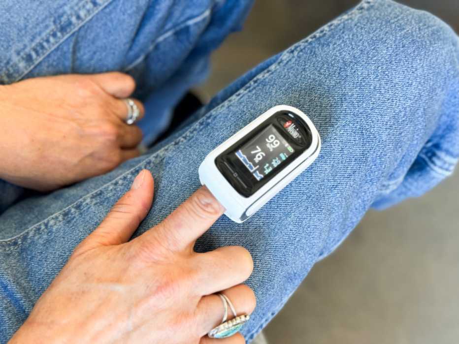 a person with a pulse oximeter on their finger