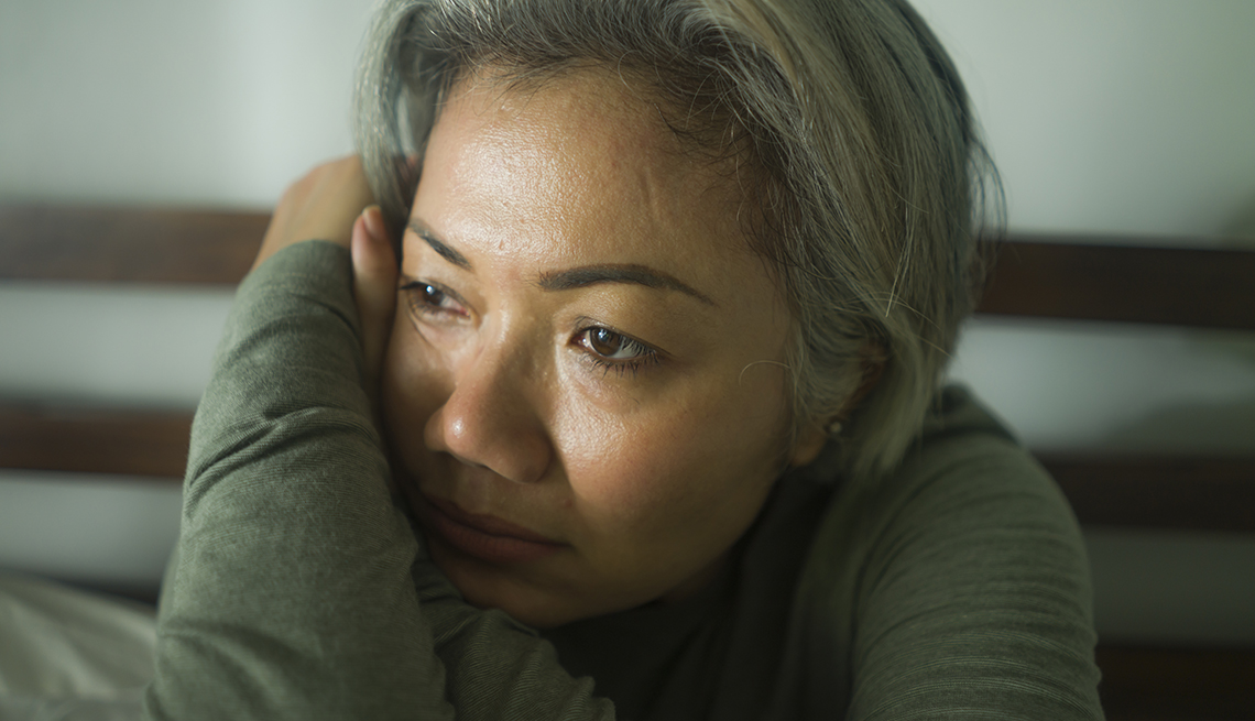 Woman looking depressed, leaning her head on her arm