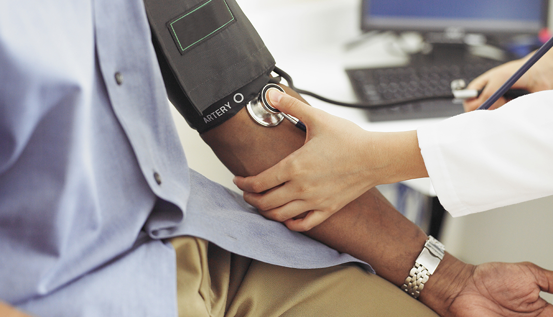 Doctor takes patient's blood pressure