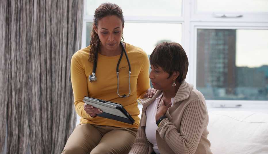 Doctor and patient using digital tablet in office