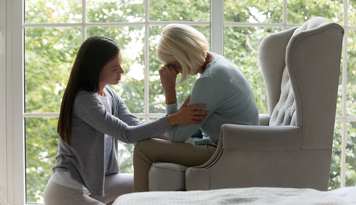 woman crying and being comforted