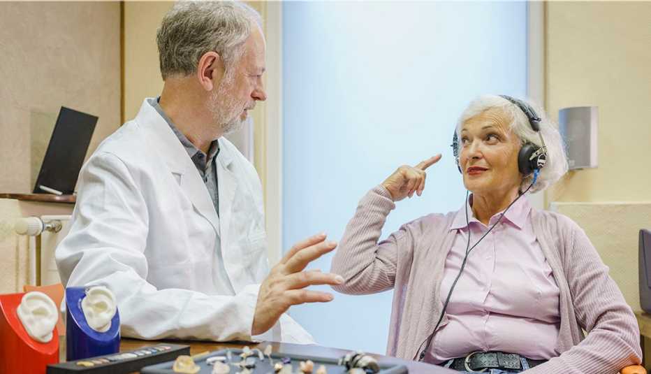 doctor administering a hearing test to a woman