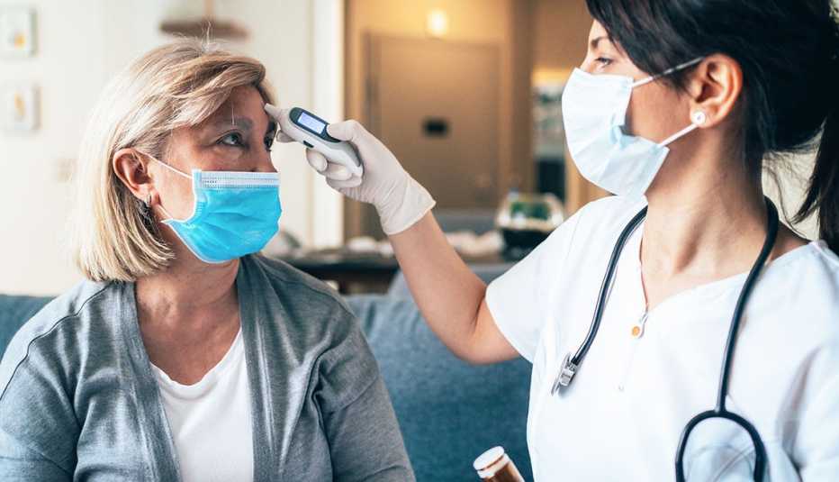 Medical provider takes the temperature of a patient during an office visit