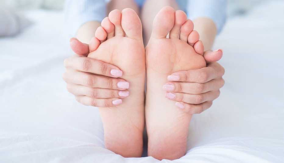 Woman holding her feet