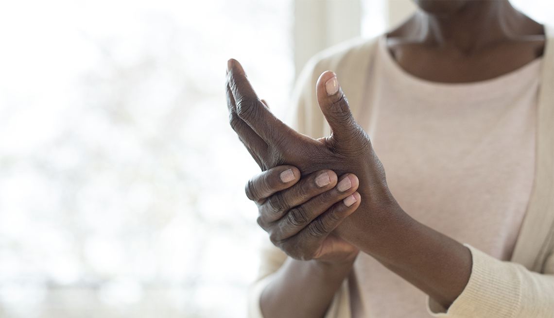 Mature woman with painful hand from arthritis