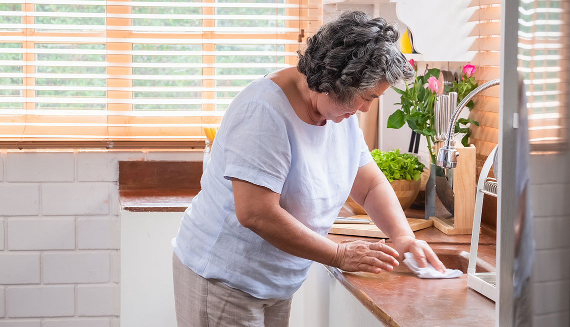 a woman cleaning a sink