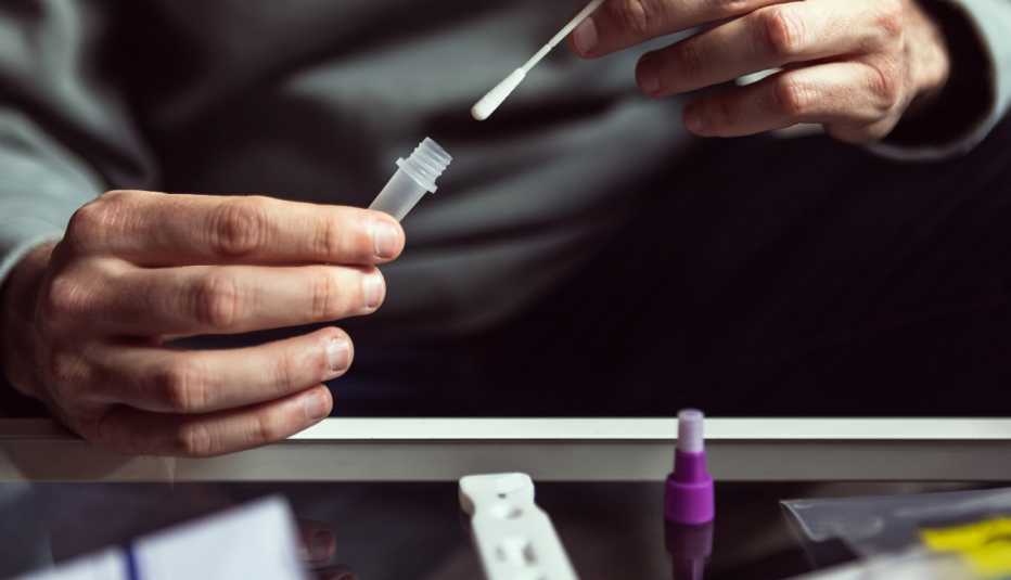 man performing an at-home covid swab test