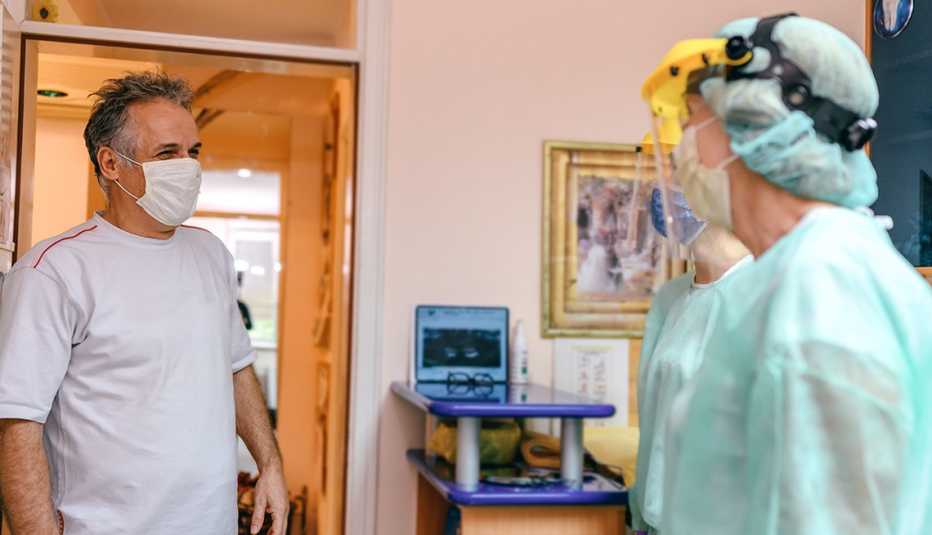 patient at dental office, staff wearing PPE