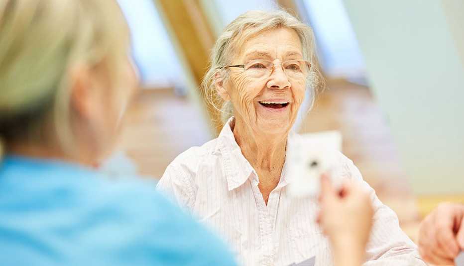close up of woman playing cards at a table