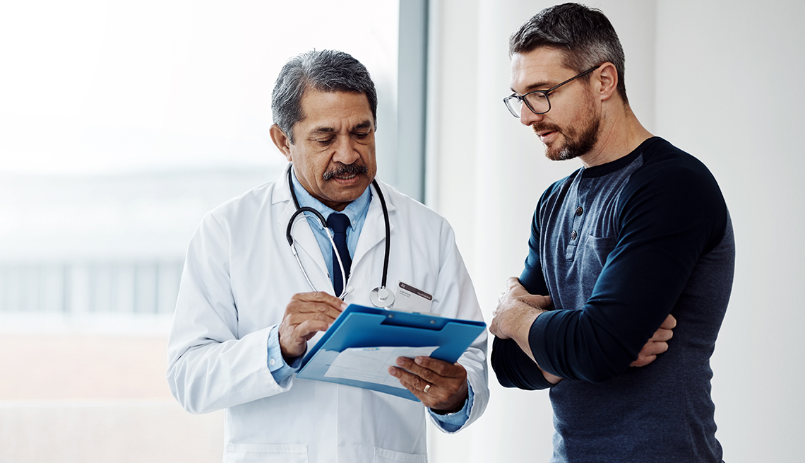 A man is talking to a doctor