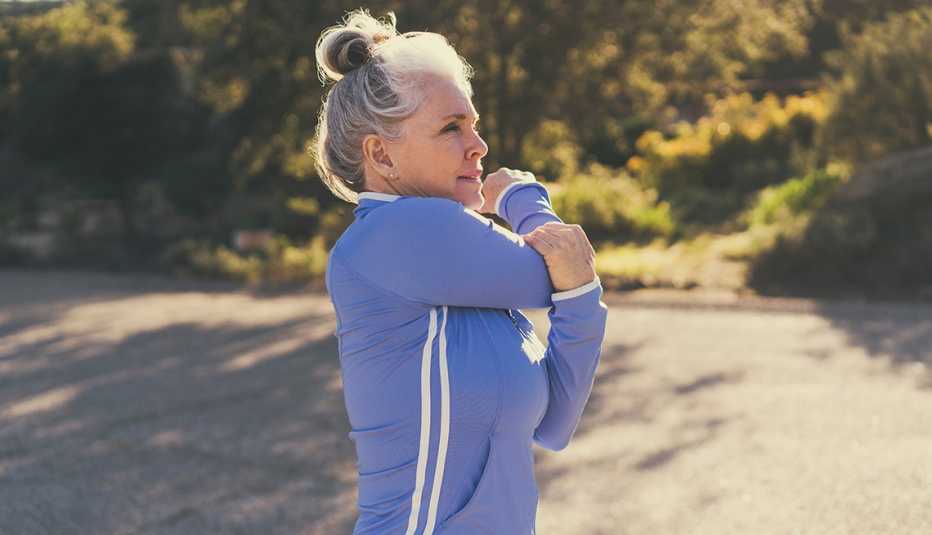 a woman is stretching outside