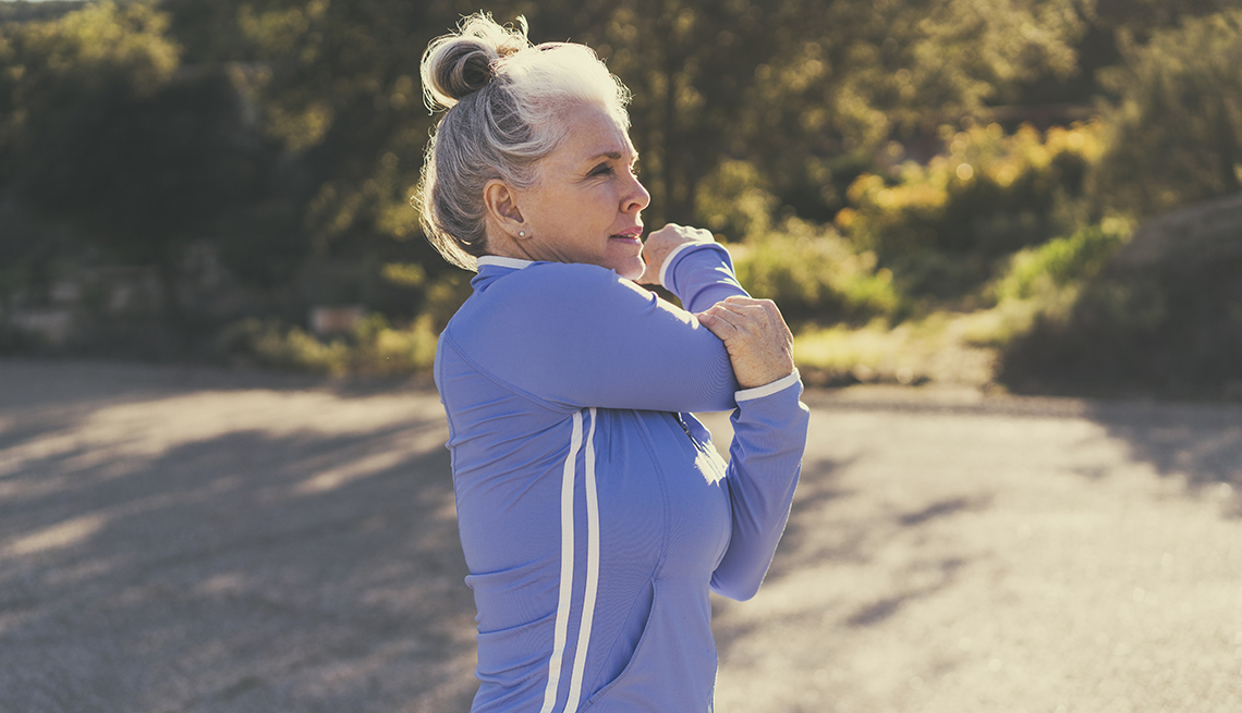 a woman is stretching outside