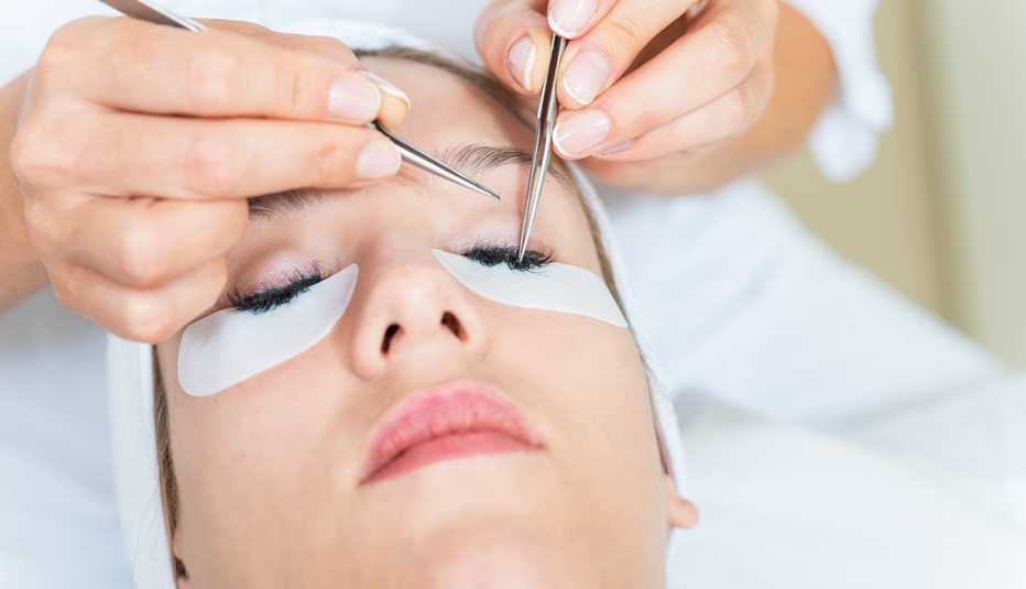 Woman getting eyelash extensions put on Woman getting eyelash extensions put on