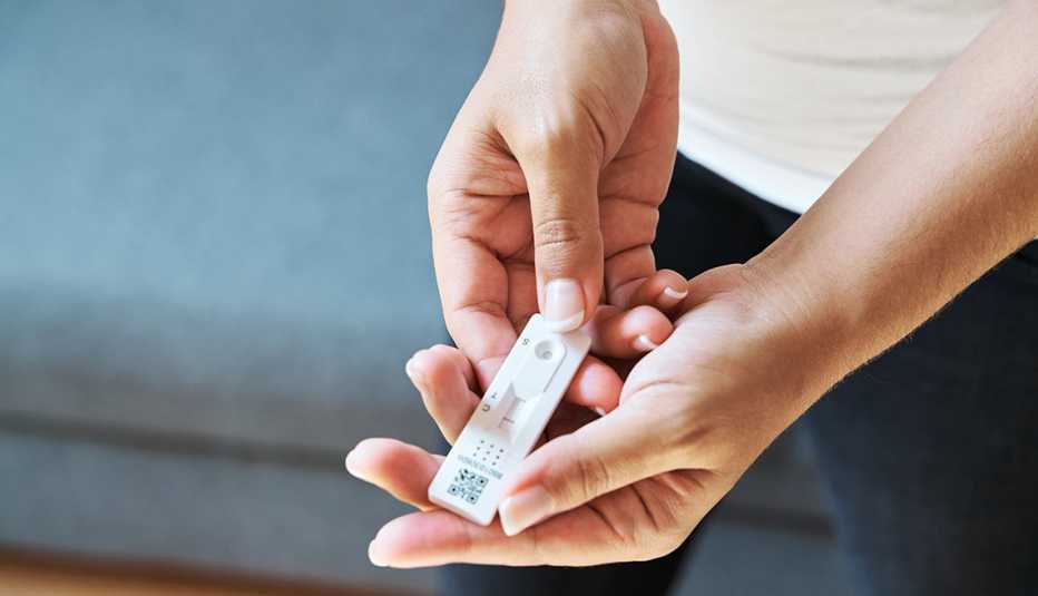 Close-up view of a woman taking a Covid-19 rapid antigen test at home. Medicine and coronavirus concept. Close-up view of a woman taking a Covid-19 rapid antigen test at home. Medicine and coronavirus concept.
