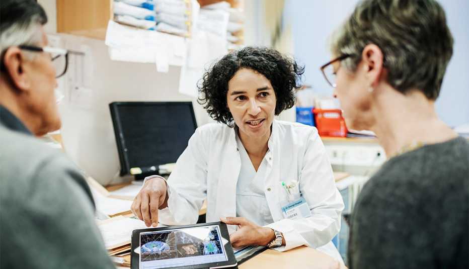 A clinical doctor explaining some test results to an older couple.