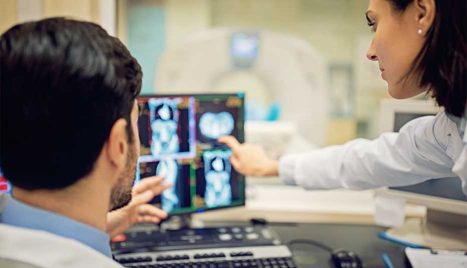 Doctors are working with CT scan in hospital