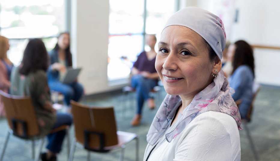 With her support group in the background, the cancer survivor poses for a portrait.