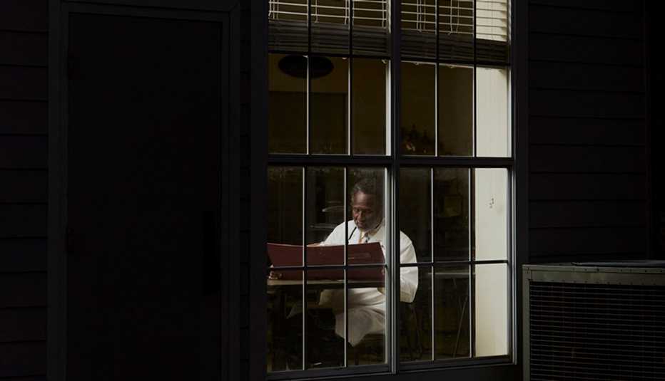 dr batie working into the night as seen from outside a window