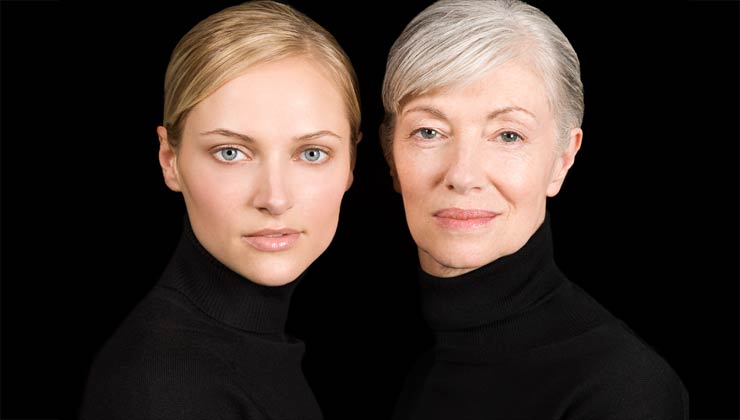 Young and senior woman against black background Young and senior woman against black background