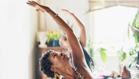 shot of woman in reverse warrior pose during class in yoga studio  shot of woman in reverse warrior pose during class in yoga studio