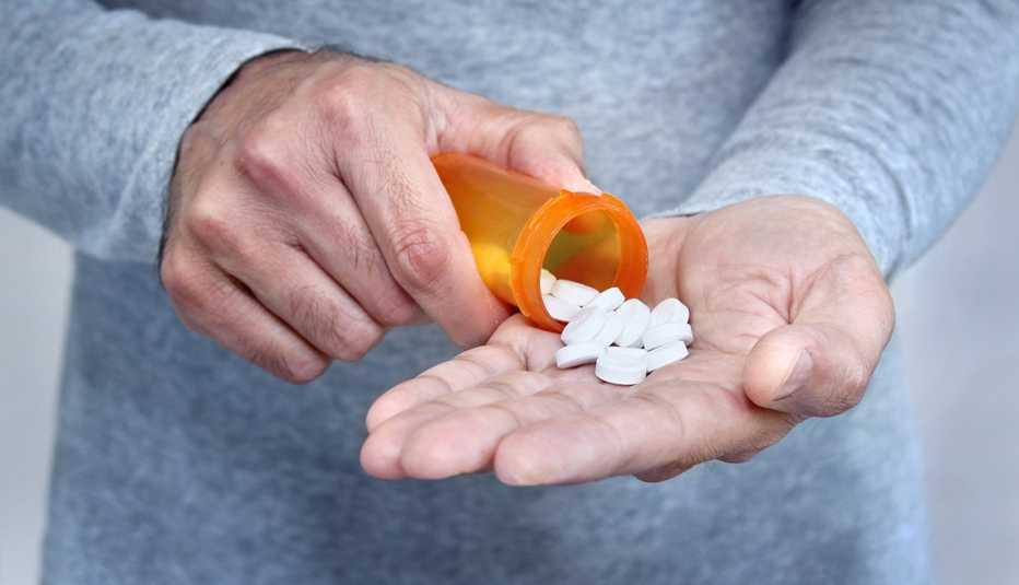 Man Taking White Colored Pills