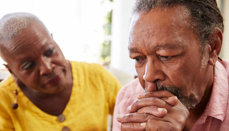 A man and woman sitting at home