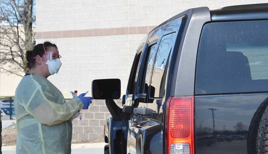 Jennifer Homan, RN, manager of Trauma Services at Franciscan Health Crown Point, prepares to swab a patient during COVID-19 testing on March 17, 2020, outside the Emergency Department at Franciscan Health Crown Point