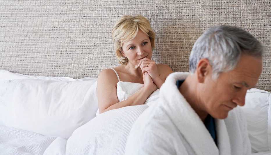 A couple sitting in bed together