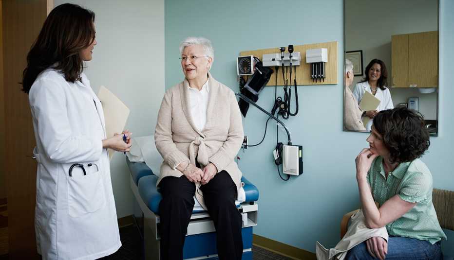 Mature female patient in exam room with doctor